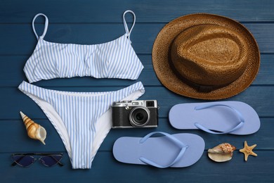 Flat lay composition with beach objects on blue wooden background