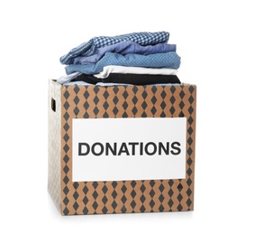 Photo of Donation box with clothes on white background