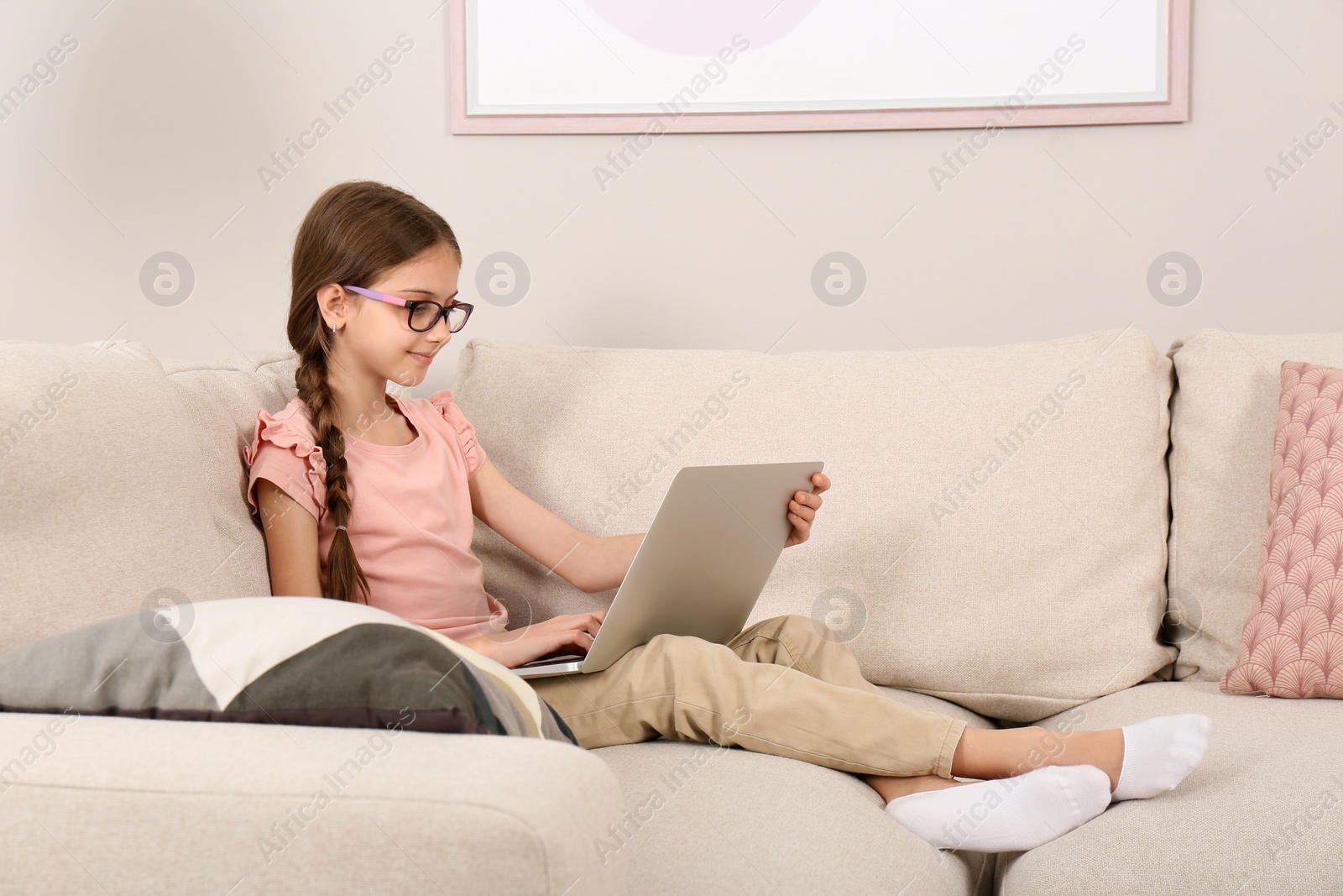 Photo of Girl with laptop on sofa at home