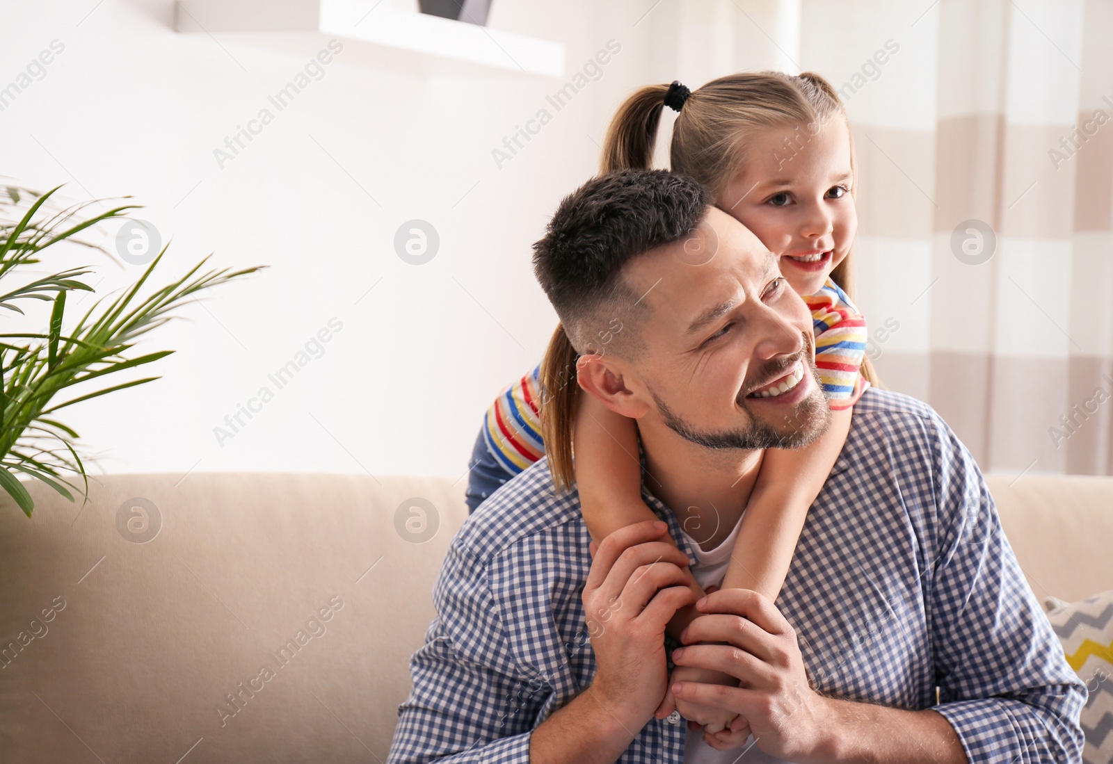 Photo of Dad and daughter spending time together at home. Happy Father's Day