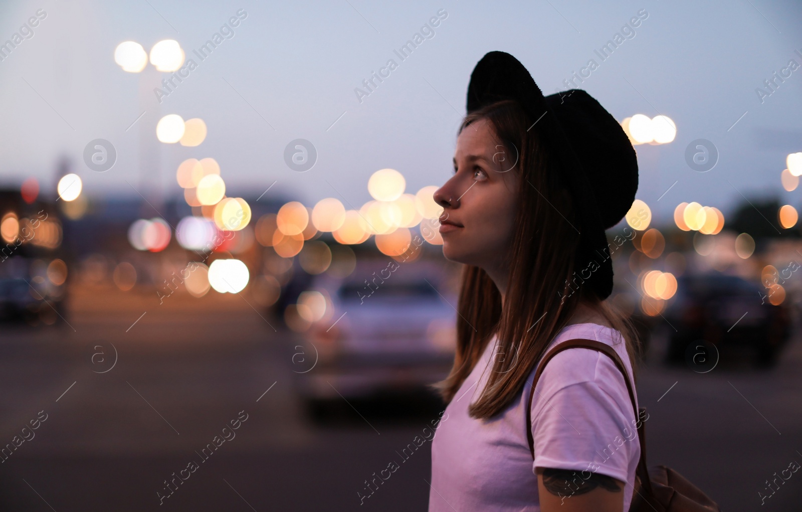 Photo of Young woman in stylish outfit on city street