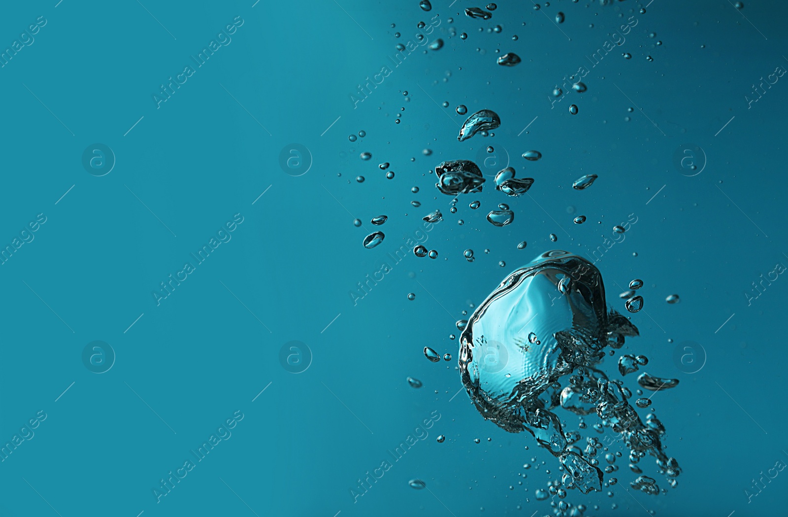 Photo of Air bubbles in water on blue background. Space for text