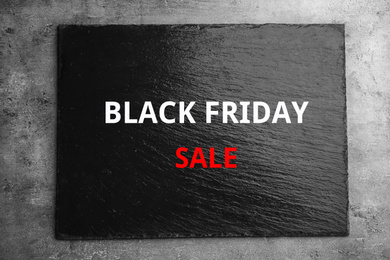 Textured slate board with text BLACK FRIDAY SALE on dark background, top view
