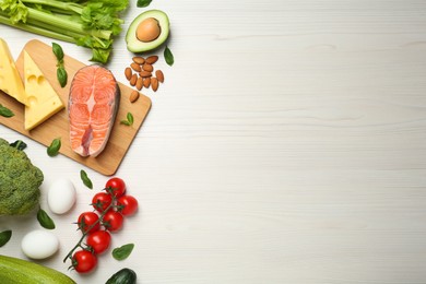 Photo of Flat lay composition with fresh organic products on white wooden table, space for text. Keto diet