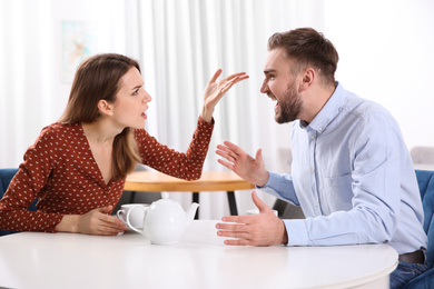 Photo of Couple having quarrel in cafe. Relationship problems