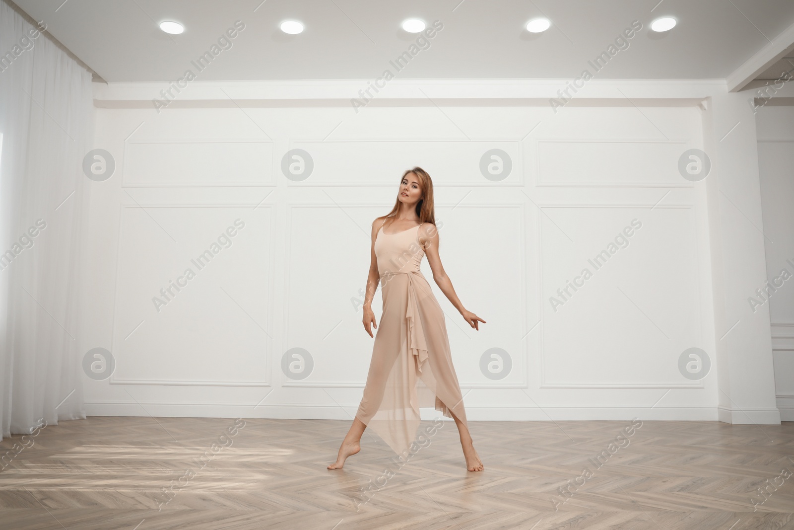 Photo of Beautiful professional dancer practicing moves in studio