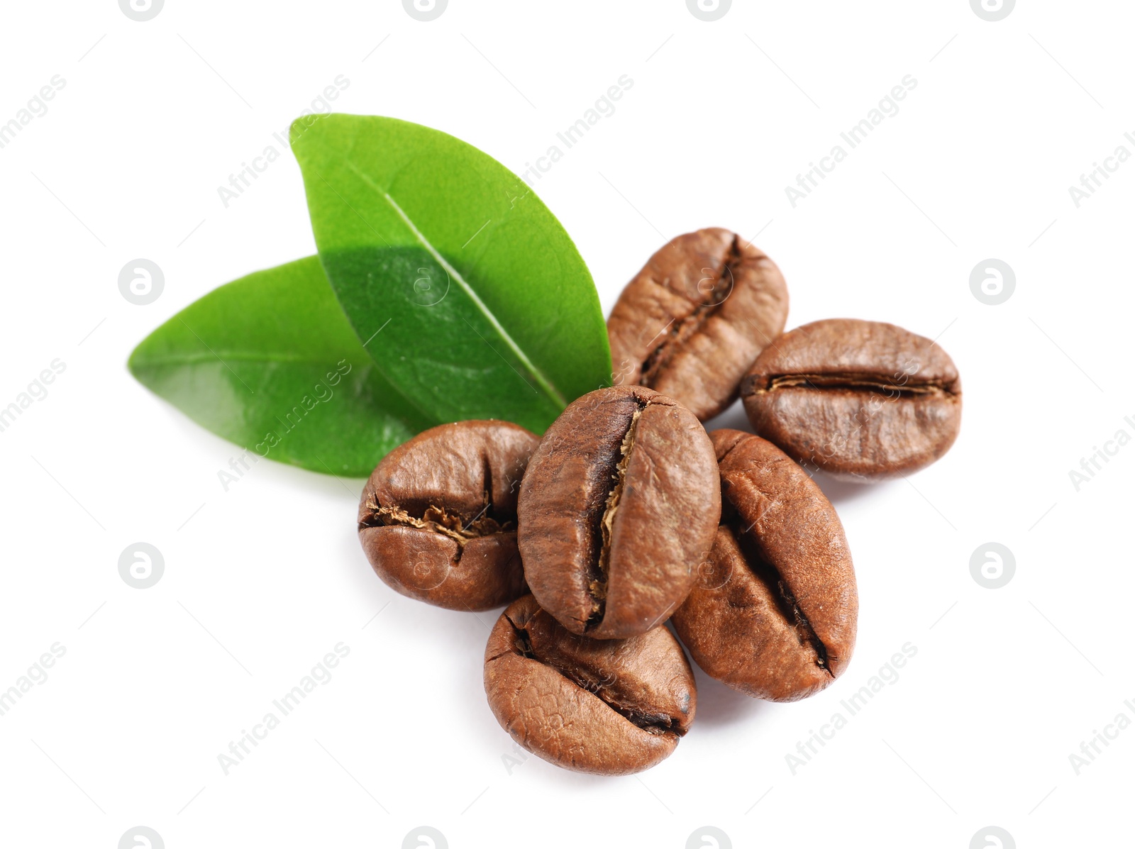 Photo of Roasted coffee beans and fresh green leaves on white background