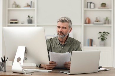 Photo of Professional accountant working at wooden desk in office