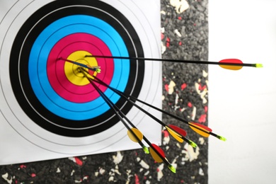 Many arrows in archery target on wall