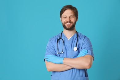 Photo of Doctor or medical assistant (male nurse) with stethoscope on turquoise background. Space for text