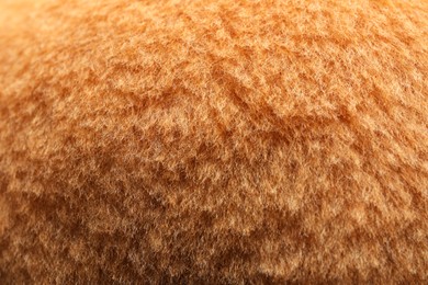 Texture of orange faux fur as background, closeup