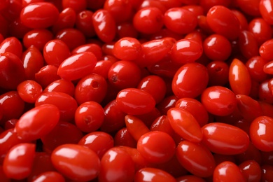 Fresh ripe goji berries as background, closeup