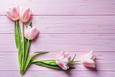 Beautiful composition with tulips for Mother's Day on wooden background