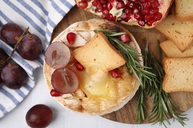 Photo of Flat lay composition with tasty baked camembert on white tiled table