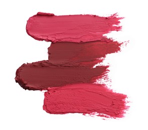 Smears of bright lipsticks on white background, top view