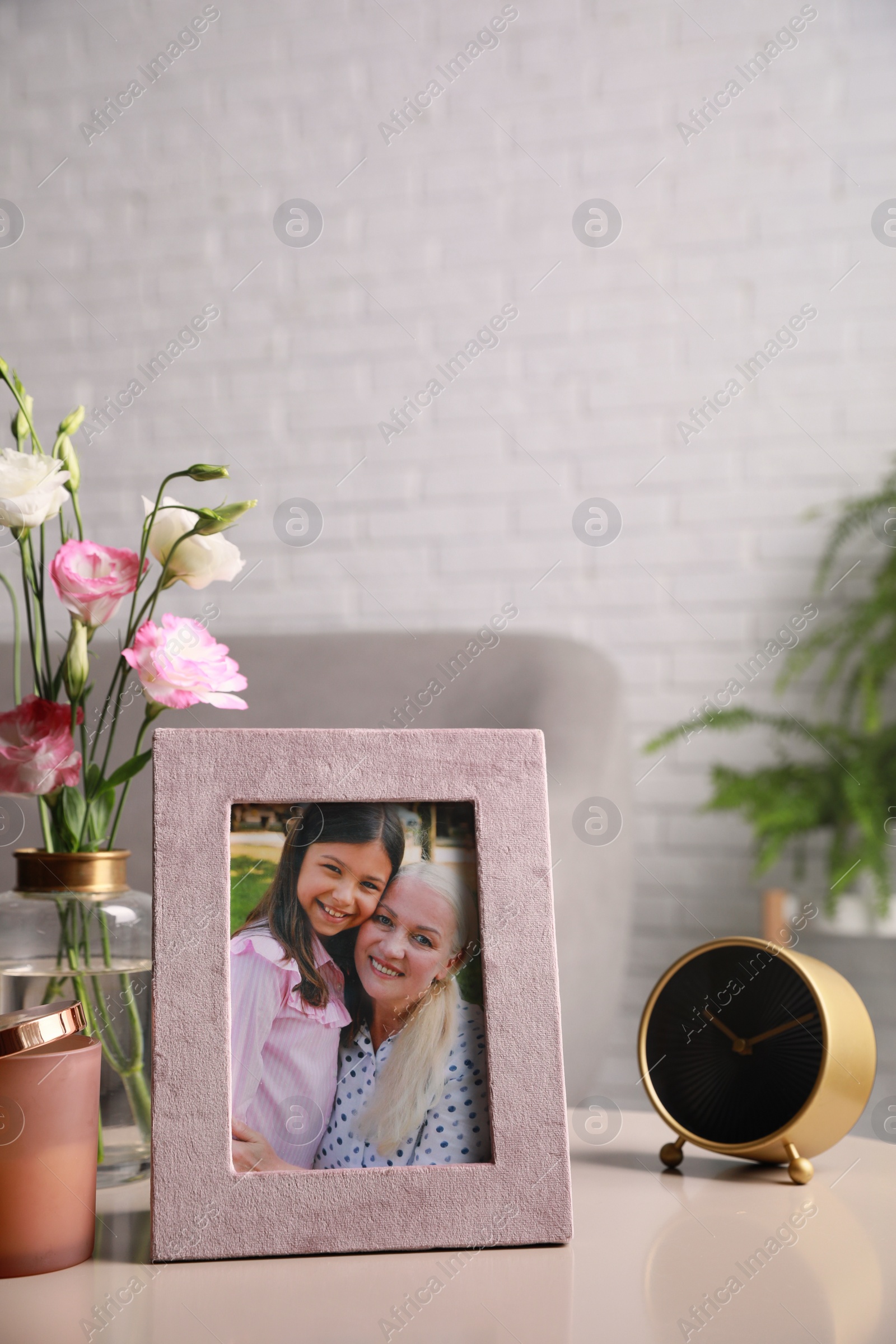 Photo of Framed family photo on light table in living room