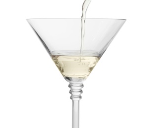 Pouring martini from bottle into glass on white background