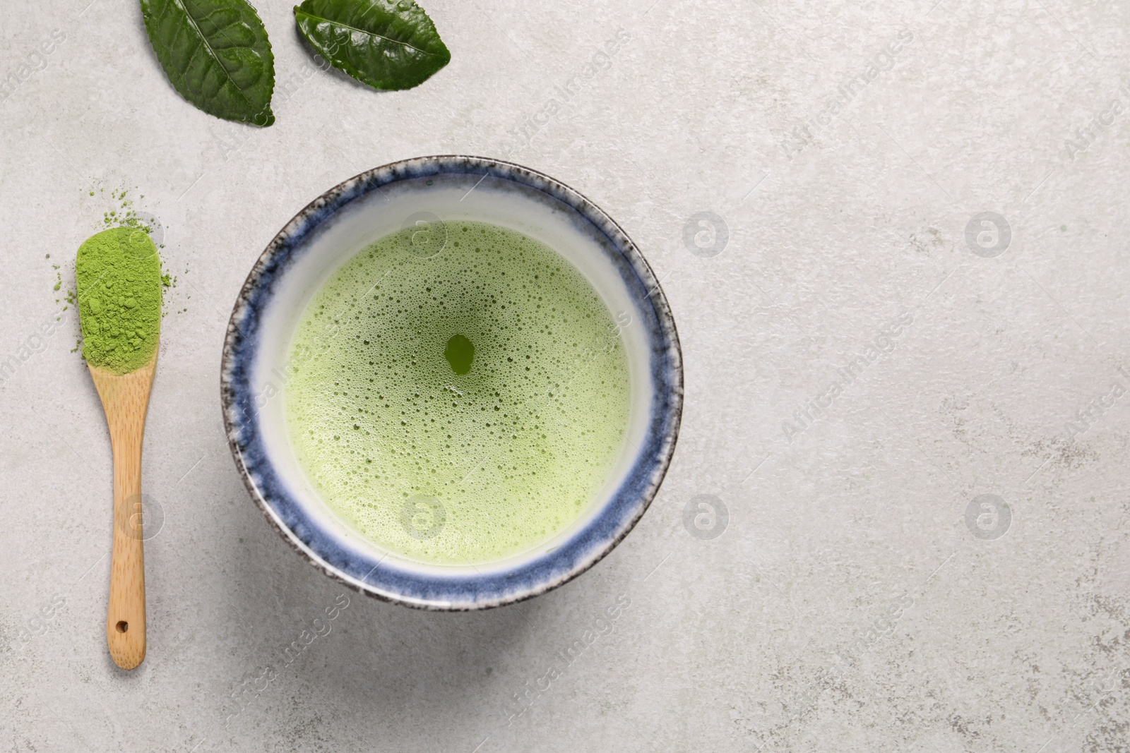 Photo of Flat lay composition with matcha tea on light gray textured table, space for text