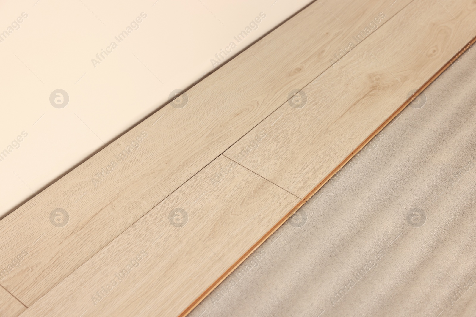 Photo of Parquet planks on floor near wall in room prepared for renovation