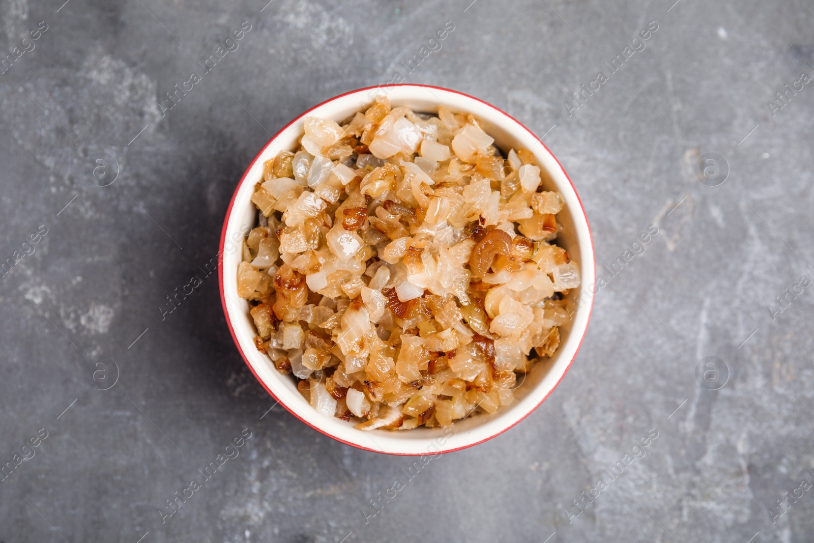 Photo of Tasty fried onion on grey table, top view