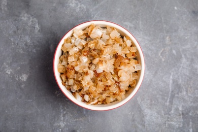 Photo of Tasty fried onion on grey table, top view
