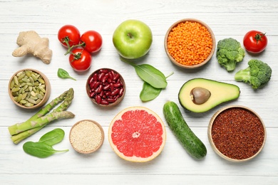 Photo of Different vegetables, seeds and fruits on white wooden table, flat lay. Healthy diet