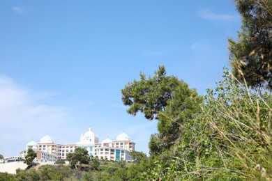 Photo of Distant view of beautiful hotel on sunny summer day