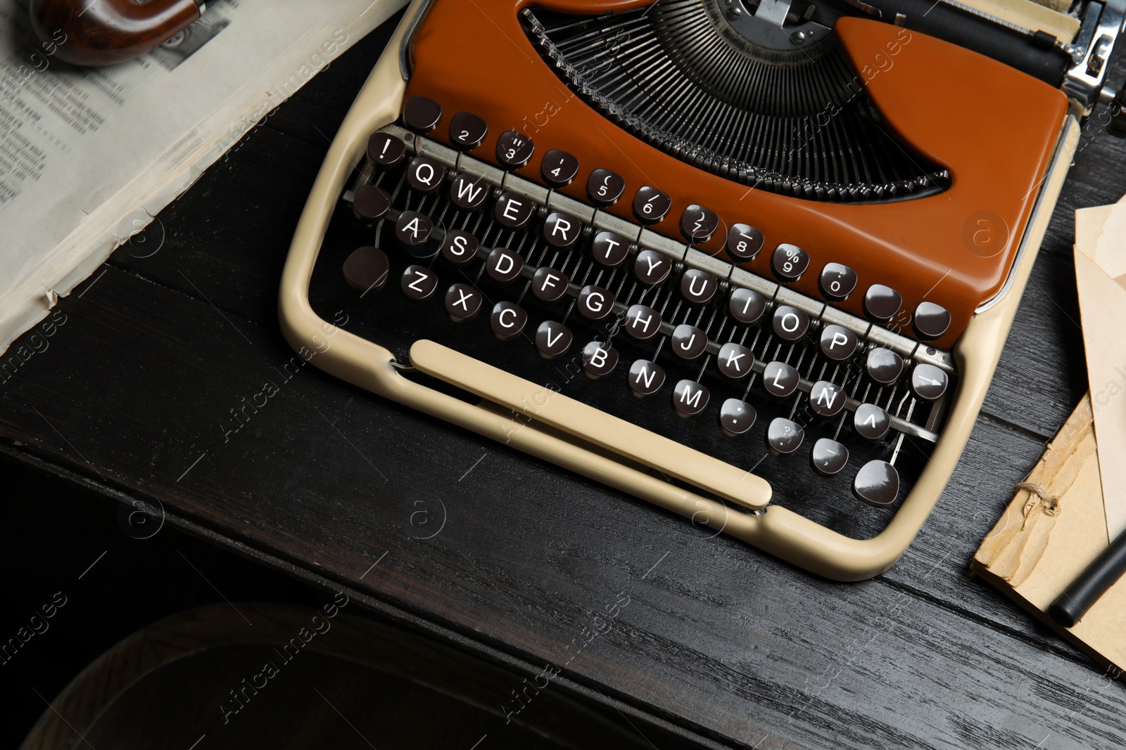 Photo of Typewriter on dark wooden table, closeup. Detective's workplace