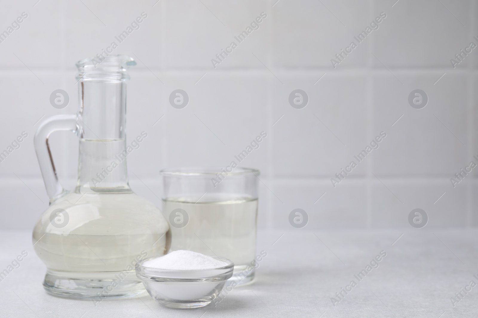 Photo of Vinegar and baking soda on light table, space for text