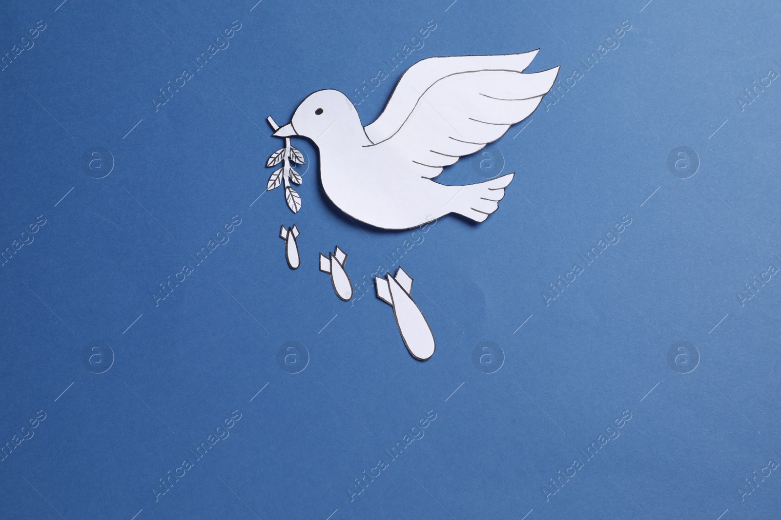 Photo of White paper dove with olive branch and bombs on blue background, flat lay