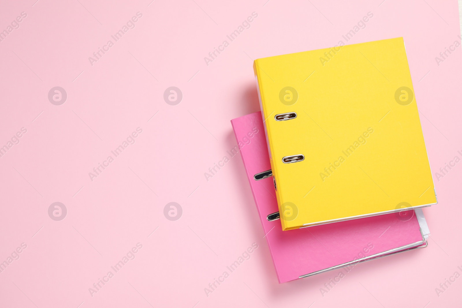 Photo of Office folders on pink background, flat lay. Space for text