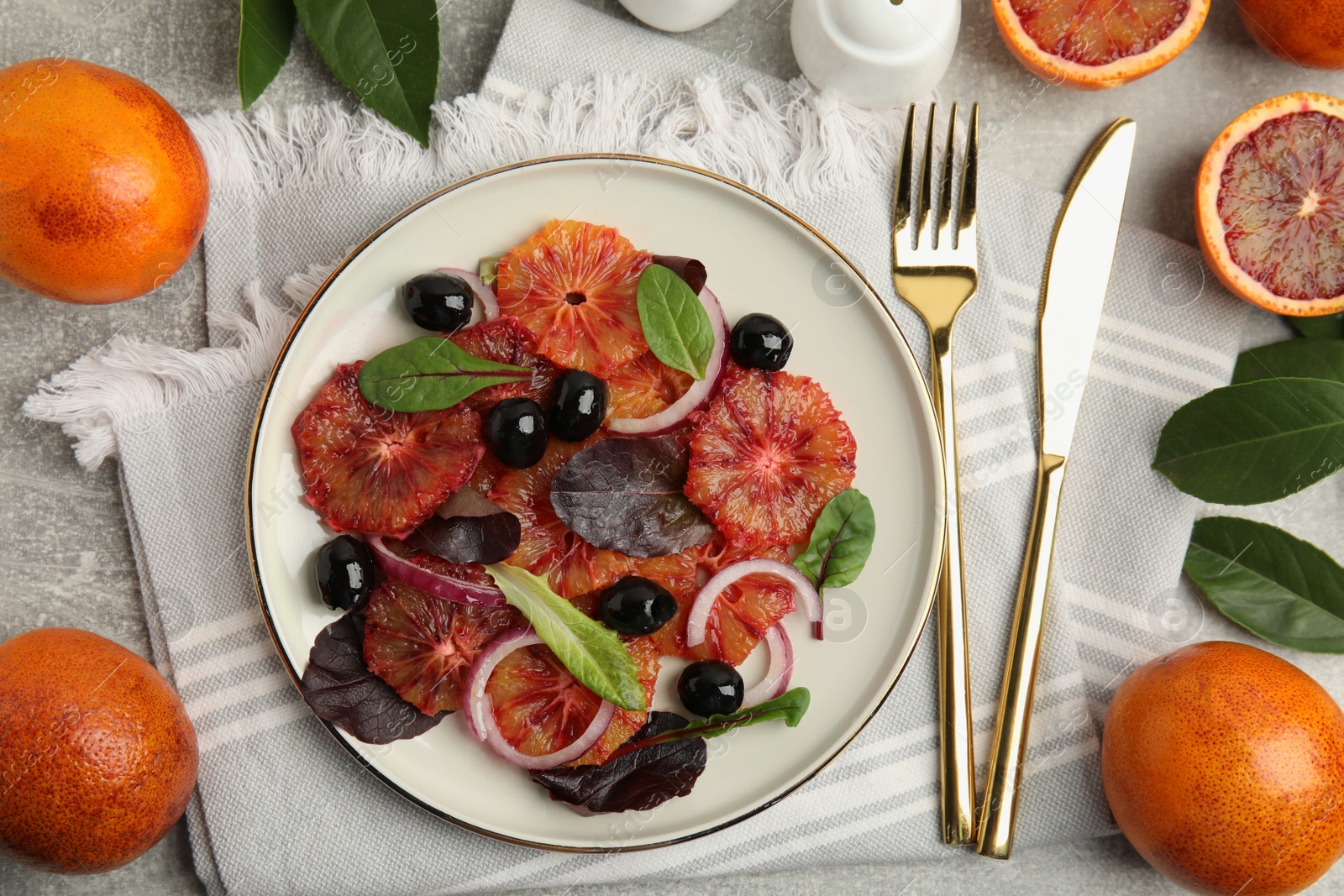 Photo of Delicious sicilian orange salad served on grey table, flat lay