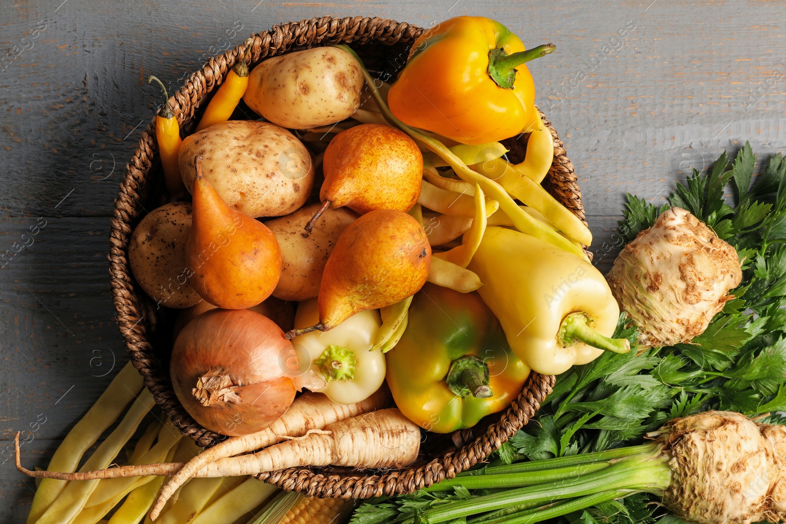 Photo of Different fresh ripe vegetables and fruits on grey wooden table, flat lay