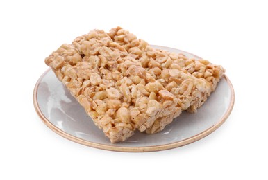 Photo of Plate with tasty peanut bars (kozinaki) isolated on white