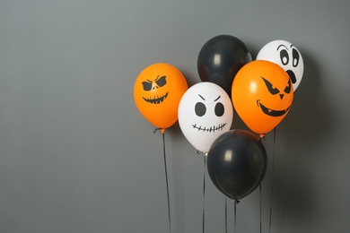 Color balloons for Halloween party on gray background. Space for text