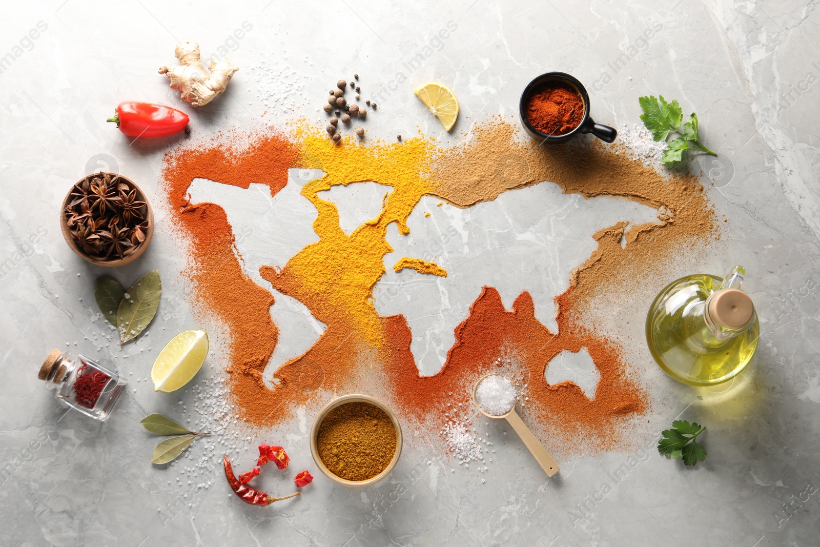 Photo of World map of different spices and products on light grey marble table, flat lay