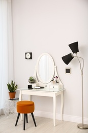 Dressing table with mirror in stylish room interior