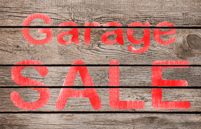 Image of Phrase GARAGE SALE written on wooden surface 