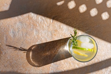 Summer refreshing lemonade on light brown table, top view. Space for text