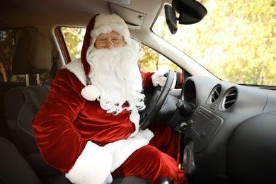 Photo of Authentic Santa Claus driving modern car, view from passenger seat