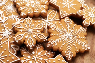 Photo of Tasty Christmas cookies on wooden plate, closeup