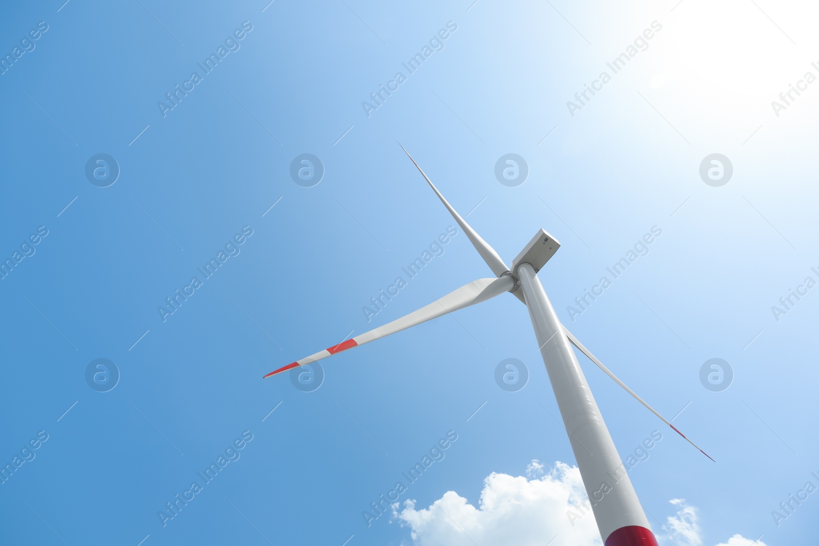 Photo of Modern wind turbine against blue sky, low angle view. Energy efficiency