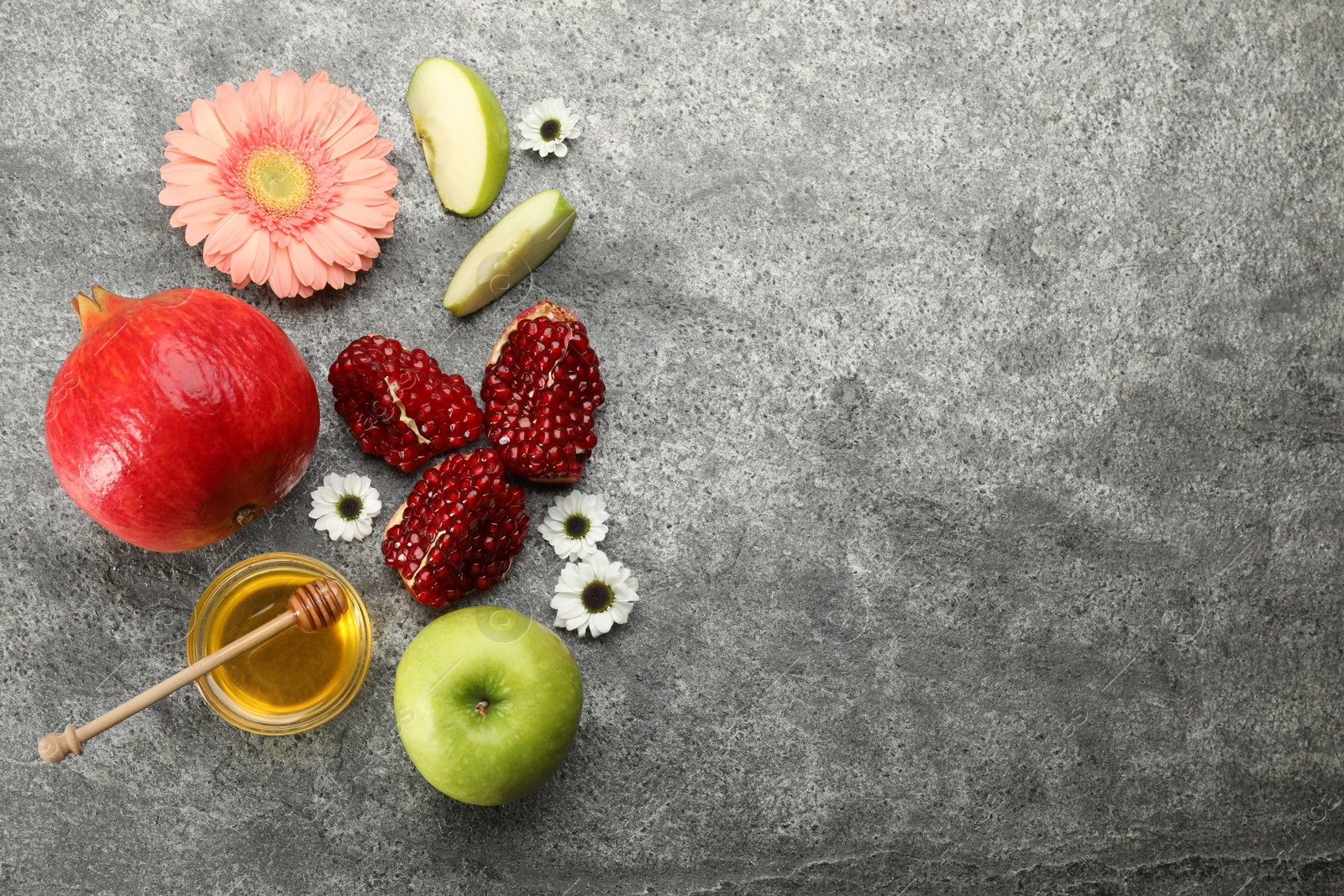 Photo of Flat lay composition with Rosh Hashanah holiday attributes on light grey background. Space for text