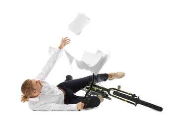 Photo of Young man dropping documents while falling off bicycle on white background