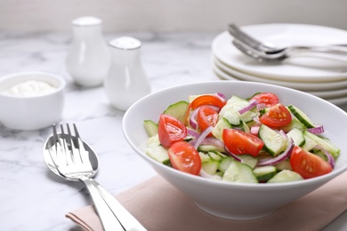 Delicious fresh cucumber tomato salad served on table, space for text