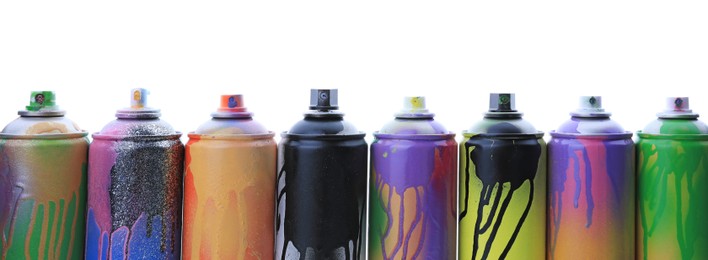 Photo of Used cans of spray paints on white background. Graffiti supplies