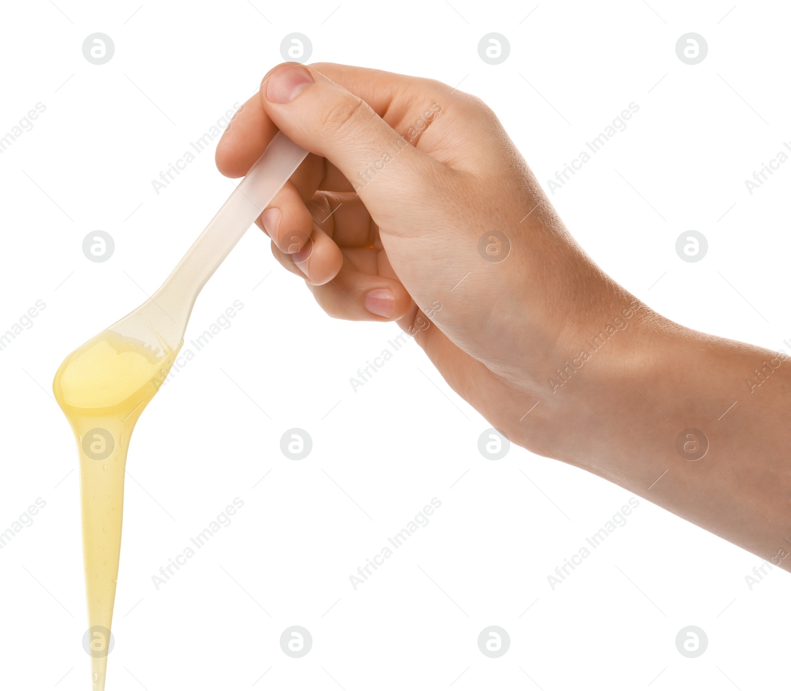 Photo of Woman holding spatula with hot depilatory wax on white background, closeup