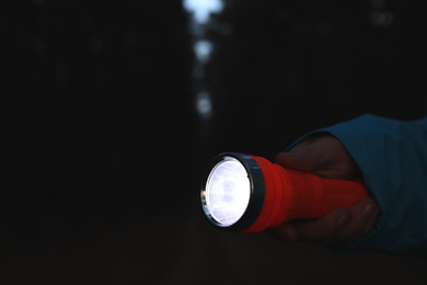Man with bright flashlight at night, closeup