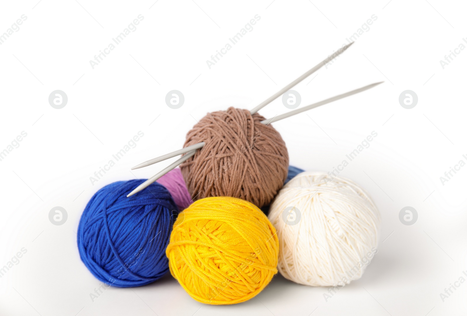 Photo of Soft woolen yarns and knitting needles on white background