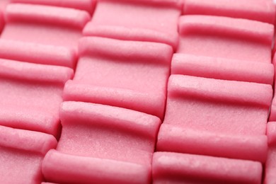 Photo of Tasty pink chewing gums as background, closeup